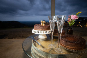 cake and champagne flutes on a barrel