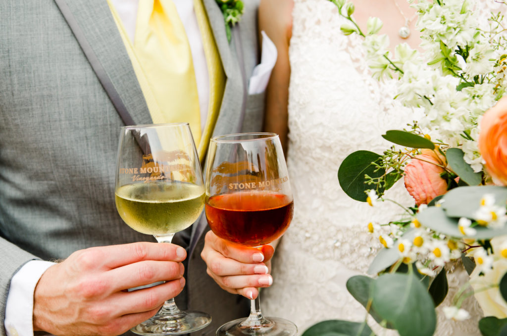 closeup of hands holding wine glasses