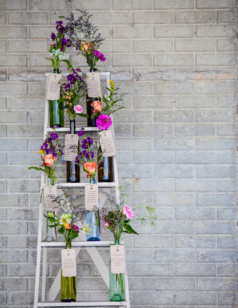 ladder with bottles holding flowers